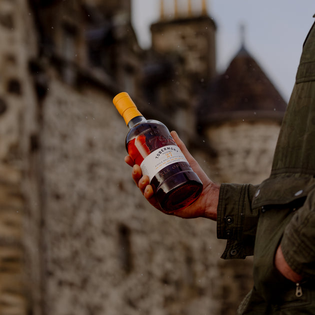 Man Holding Hebridean Series 27 Year Old with Duart Castle Backdrop