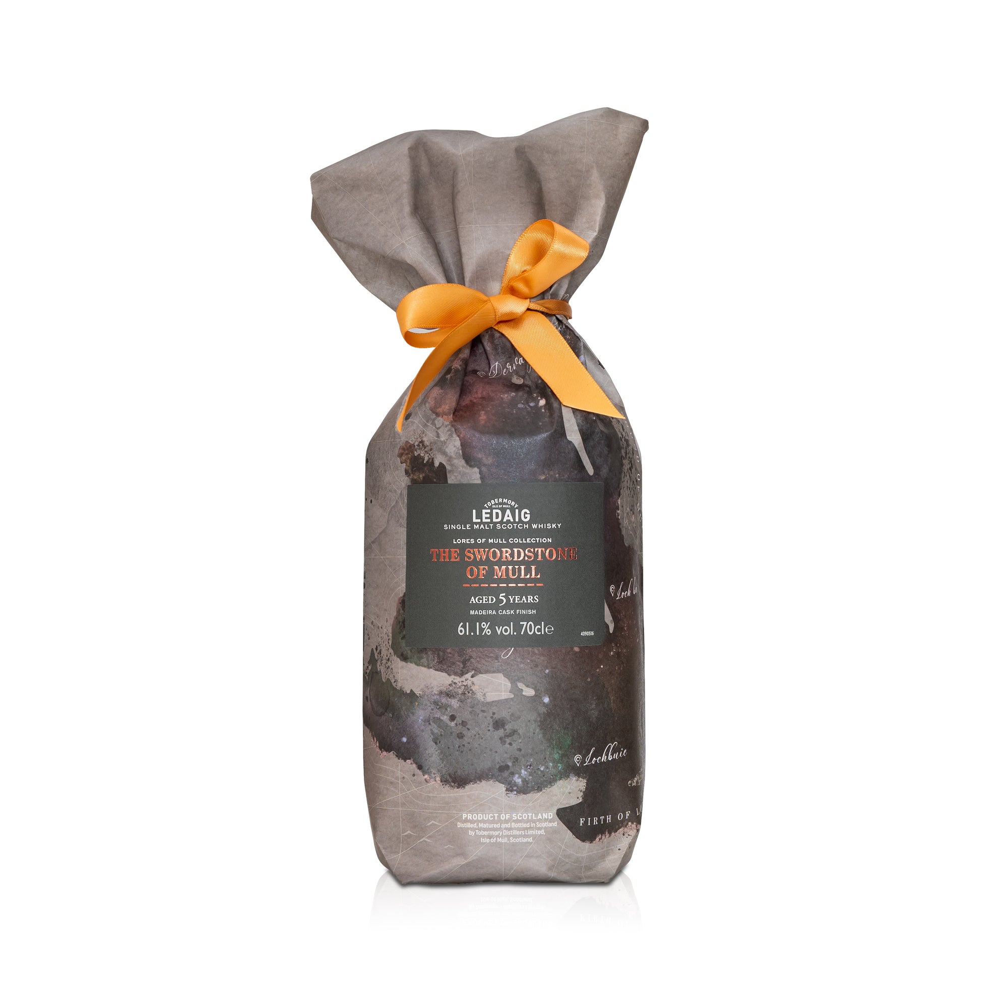 Bottle of Ledaig whisky wrapped in gray paper with a yellow ribbon on a white background