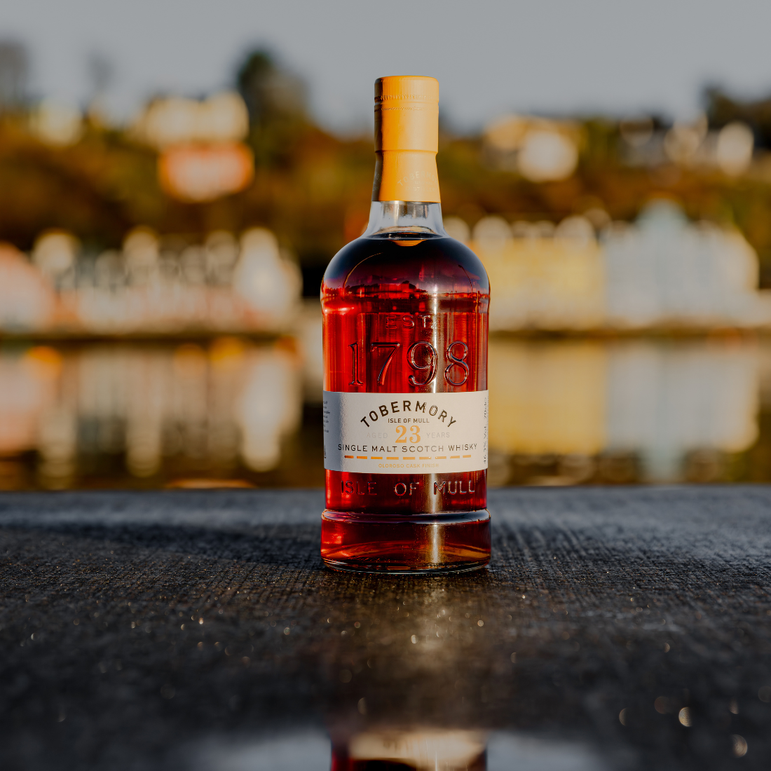 Tobermory Hebridean Series 23 Year Old Bottle with Tobermory Bay Backdrop