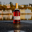 Tobermory Hebridean Series 23 Year Old Bottle with Tobermory Bay Backdrop