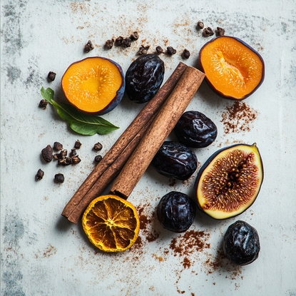 Plums, figs, dates, cinnamon sticks and cloves scattered onto a flat surface.