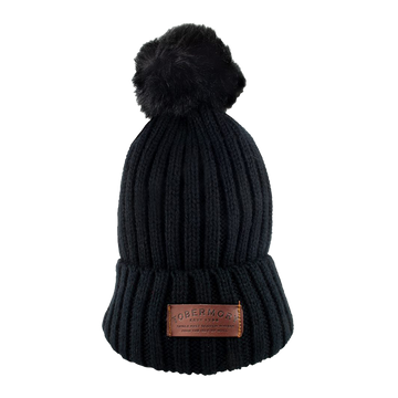 Black bobble hat with a leather Tobermory logo