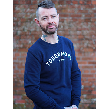 Tobermory whisky sweatshirt in blue on a male model size small